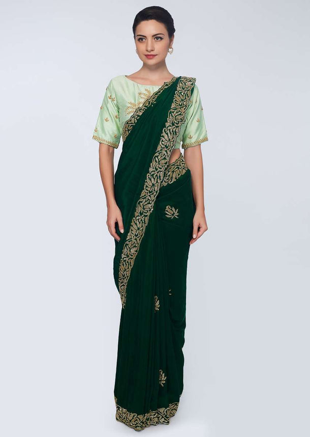 Emerald green satin saree embellished with cut dana embroidered butti and border