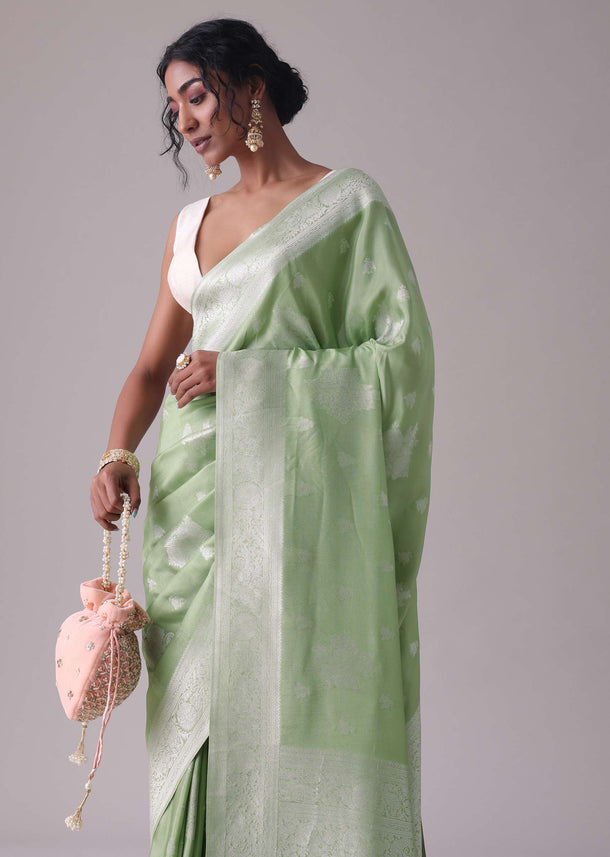 Forest shade green woven saree in Dola silk