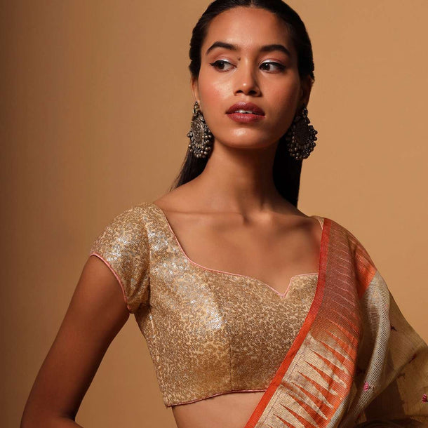 Gold Blouse In Net With Contrasting Peach Piping Around The Edges And Sequins Work All Over