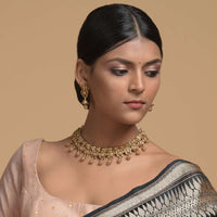 Gold Plated Necklace And Jhumka Set With Carved Geometric And Floral Design And Dangling Carved Beads Online - Kalki Fashion
