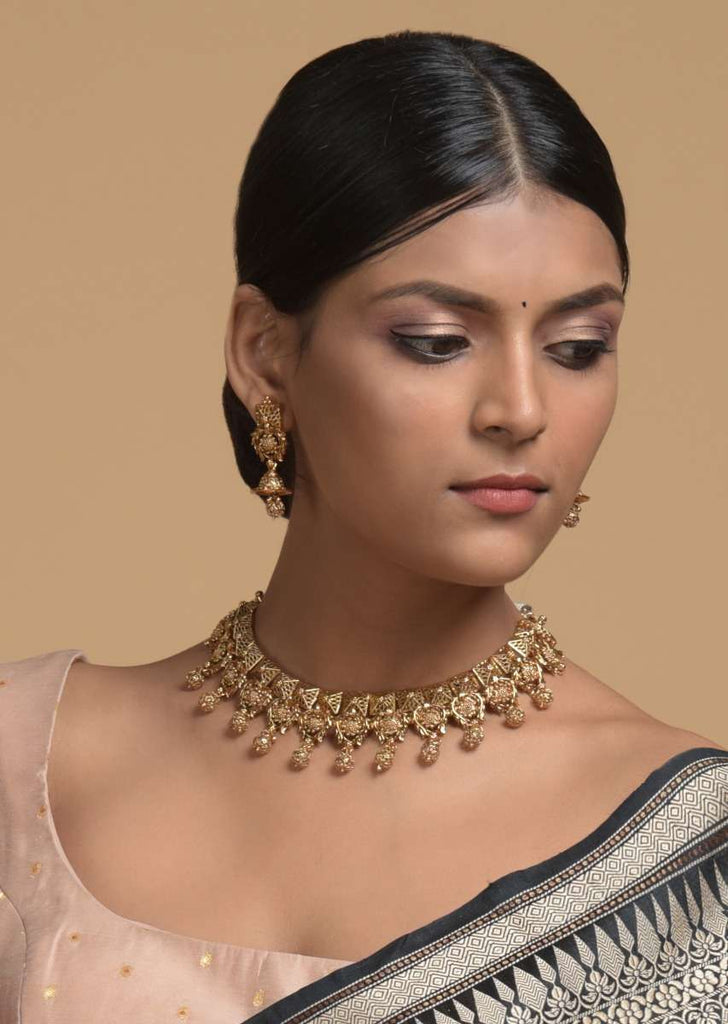 Gold Plated Necklace And Jhumka Set With Carved Geometric And Floral Design And Dangling Carved Beads Online - Kalki Fashion