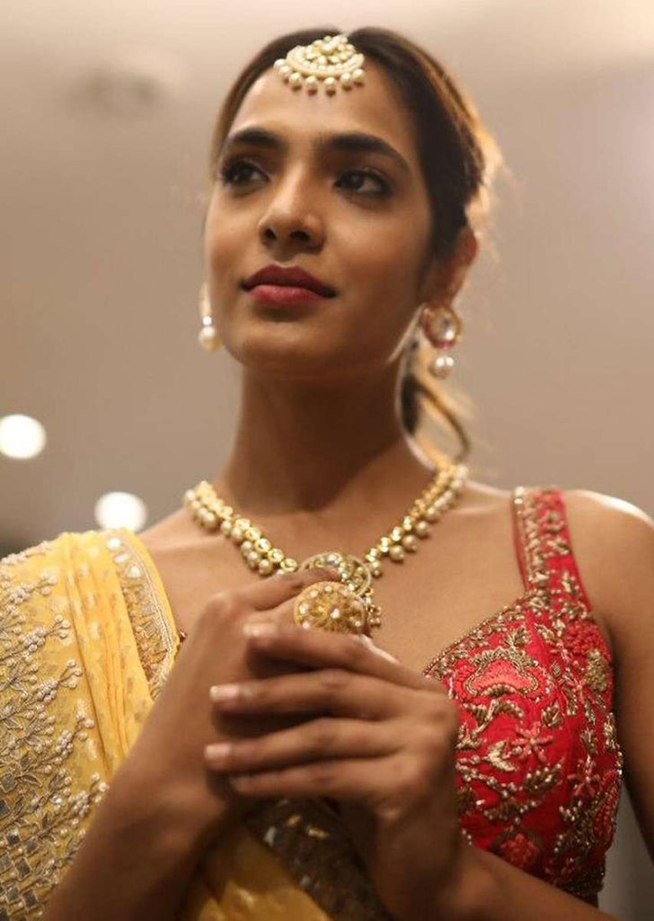 Gold Plated Necklace Studded With Kundan And Pearls Along With Round Pendant And Dangling Tassel Online - Kalki Fashion