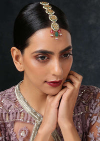 Gold Plated Mangtika With Intricate Kundan Motifs And Dangling Red And Green Stones