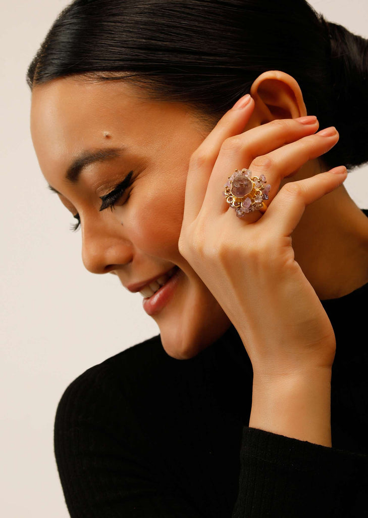 Gold Plated Ring With A Pale Purple Semi Precious Stone Centre And Tiny Stone Pieces All Over