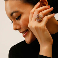 Gold Plated Ring With A Pale Purple Semi Precious Stone Centre And Tiny Stone Pieces All Over