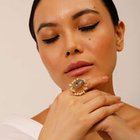 Gold Plated Ring With An Oval Shaped Grey Semi Precious Stone And Moti Tassels