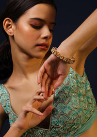 Gold Plated Round Bangle With Blue, Red And White Bead Studded Floral Motifs