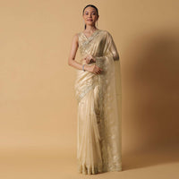 Gold Toned Foil Saree Fabricated In Tissue With Cut Dana Embellished Borders