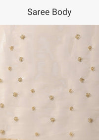 Gold Toned Foil Saree Fabricated In Tissue With Cut Dana Embellished Borders