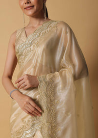 Gold Toned Foil Saree Fabricated In Tissue With Cut Dana Embellished Borders