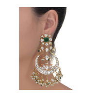 Green stone gold plated crescent danglers enhanced with kundan and pearls only on Kalki