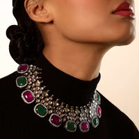 Grey Toned Choker Necklace With Kundan Work Along With Green And Maroon Semi Precious Stones Edged In Swarovski