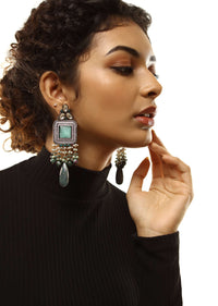 Grey Toned Earrings With Carved Green Stones In Square Shape Along With Green Semi Precious Drops