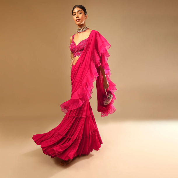 Hot Pink Crop Top Sharara Suit With An Attached Ruffle Draped And An Hand Embroidered Leaf Motifs
