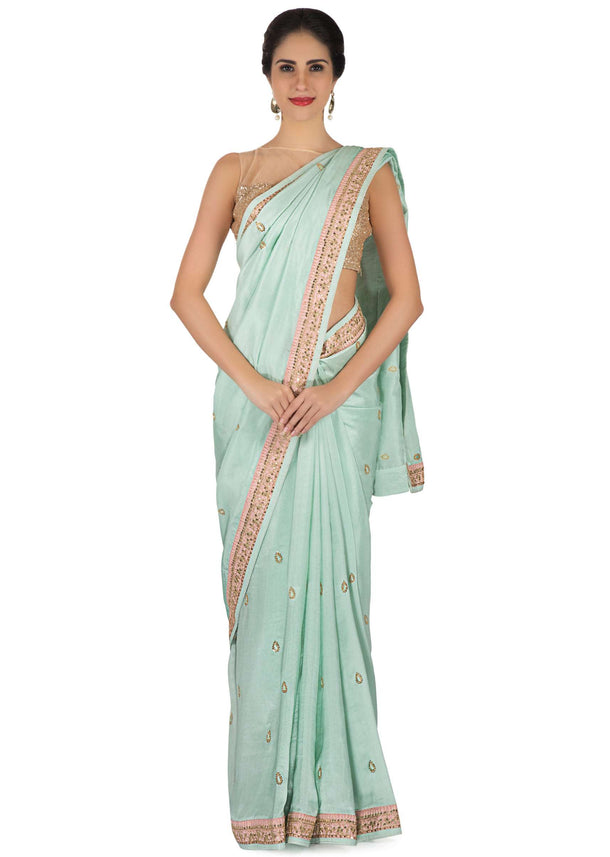 Ice blue saree in satin crepe in sequin butti and border only on Kalki