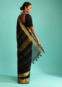 Ink Black Saree In Linen With Golden Brocade Border And Striped Pallu Along With A Matching Unstitched Blouse