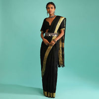 Ink Black Saree In Linen With Golden Brocade Border And Striped Pallu Along With A Matching Unstitched Blouse