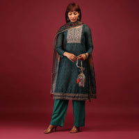 Deep Green Palazzo Suit In Tussar Silk With A Stunning Potli Bag