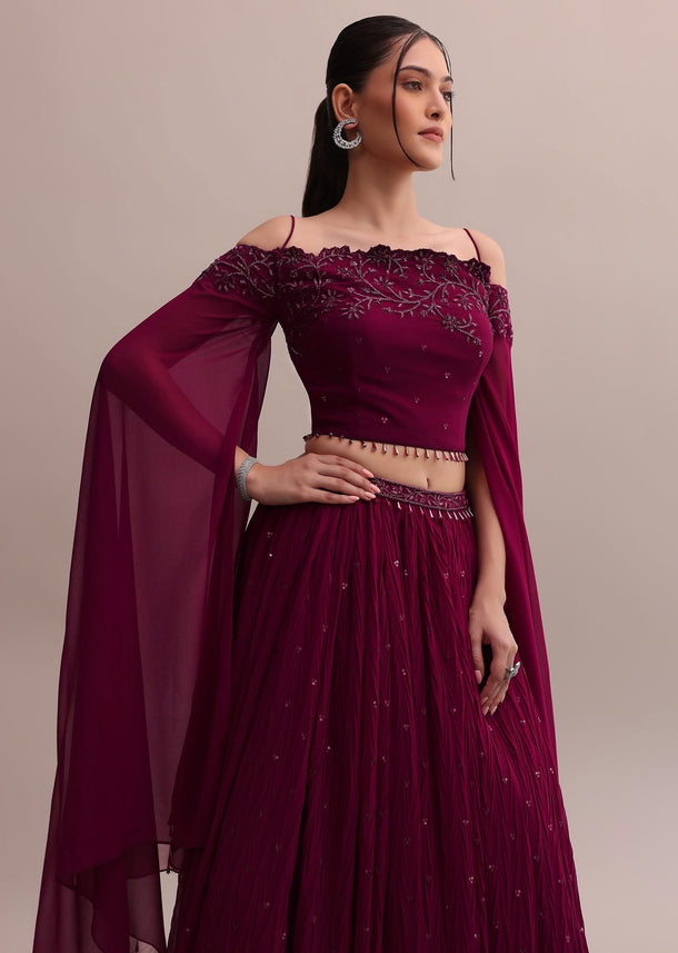 Lavish Wine Georgette Lehenga And Off-Shoulder Crop Top With Attached Cape