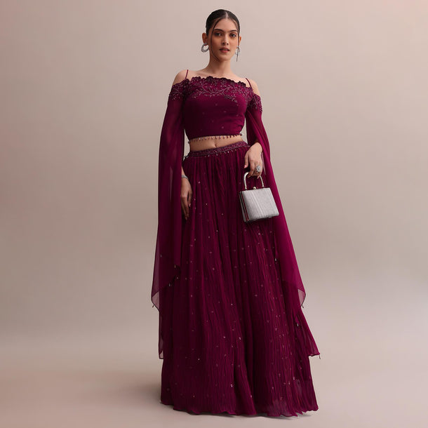Lavish Wine Georgette Lehenga And Off-Shoulder Crop Top With Attached Cape
