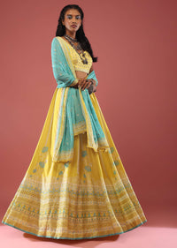 Lime Yellow Lehenga With Floral Print And A Well-Embroidered Silk Blouse Are Paired With A Blue Chiffon Dupatta