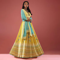 Lime Yellow Lehenga With Floral Print And A Well-Embroidered Silk Blouse Are Paired With A Blue Chiffon Dupatta