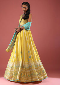 Lime Yellow Lehenga With Floral Print And A Well-Embroidered Silk Blouse Are Paired With A Blue Chiffon Dupatta