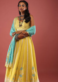 Lime Yellow Lehenga With Floral Print And A Well-Embroidered Silk Blouse Are Paired With A Blue Chiffon Dupatta