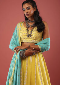 Lime Yellow Lehenga With Floral Print And A Well-Embroidered Silk Blouse Are Paired With A Blue Chiffon Dupatta