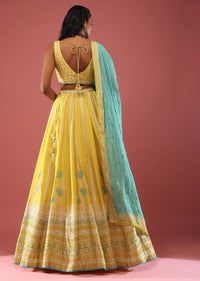 Lime Yellow Lehenga With Floral Print And A Well-Embroidered Silk Blouse Are Paired With A Blue Chiffon Dupatta