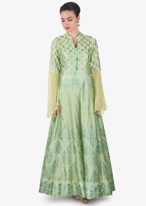 Light pista green suit featuring with foil printed butti and fancy buttons only on Kalki