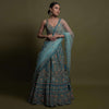 Teal Lehenga Choli In Raw Silk Hand Crafted With Embossed Embroidery In Heritage Floral Pattern