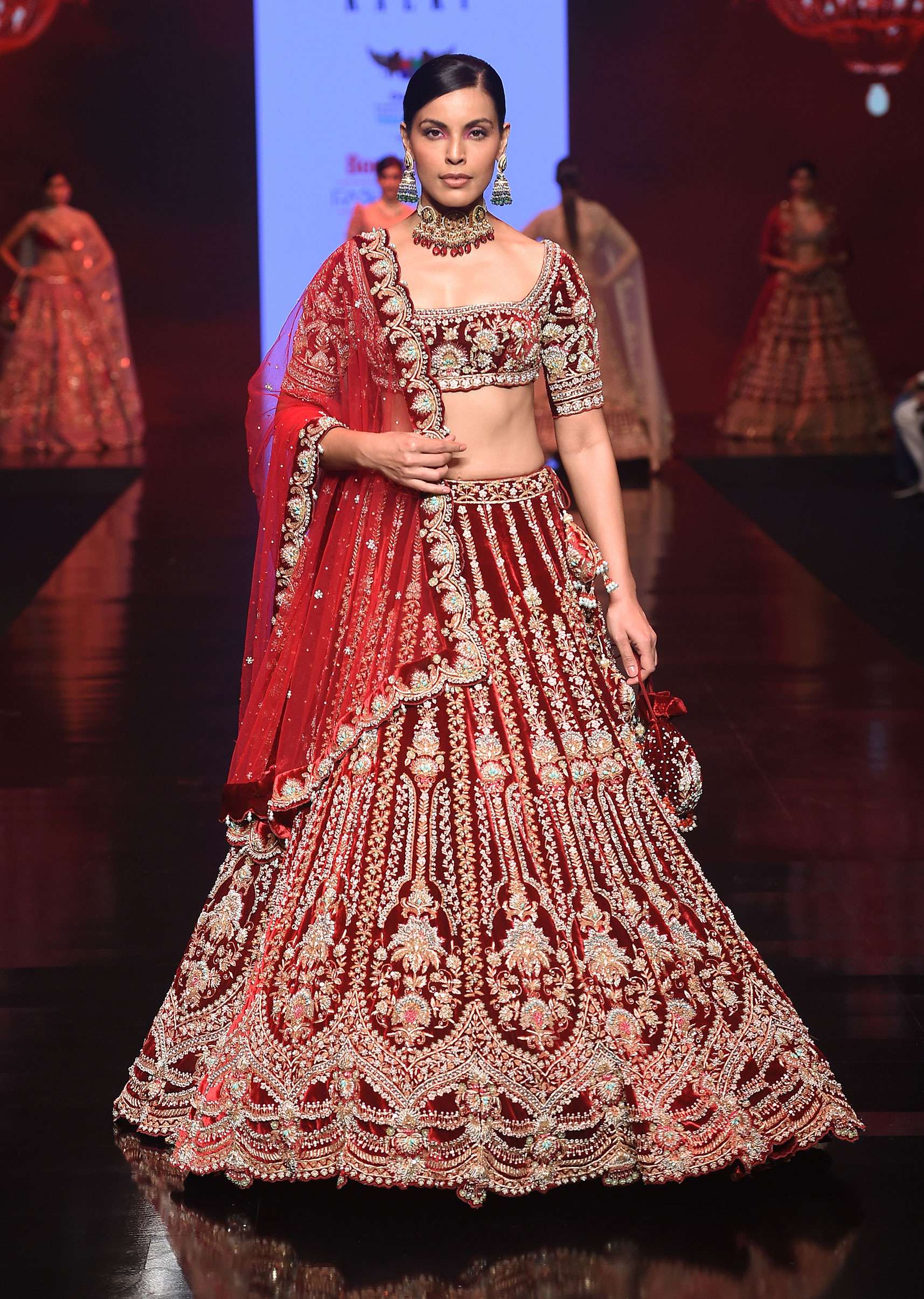 Persian Red Lehenga Choli In Velvet With Multi Colored Hand Embroidered Mughal Kalis And Floral Motifs