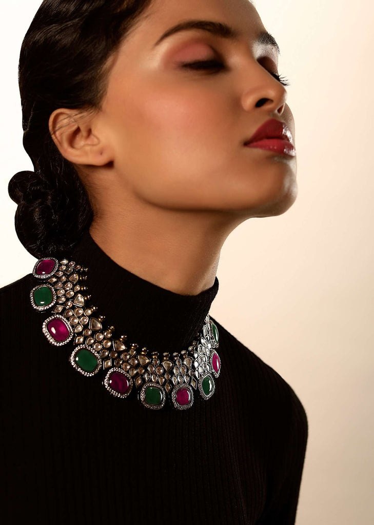 Grey Toned Choker Necklace With Kundan Work Along With Green And Maroon Semi Precious Stones Edged In Swarovski