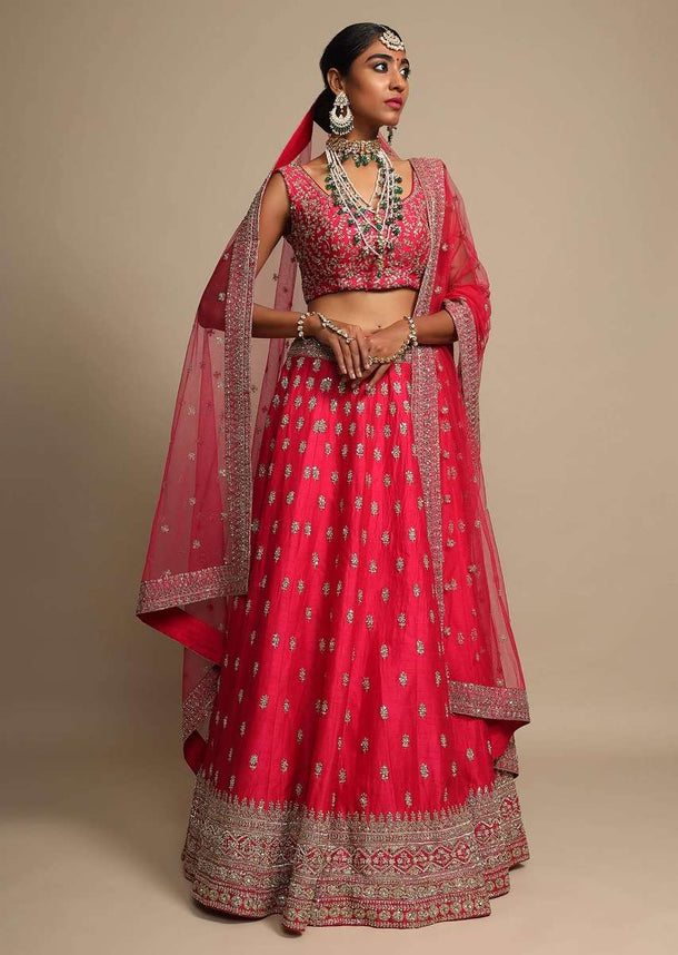 Magenta Lehenga Choli In Raw Silk With Zari Embroidered Elaborate Border And Butti Work