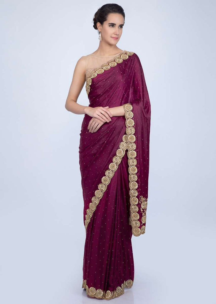 Magenta satin saree with golden scallop embroidered pallo only on Kalki