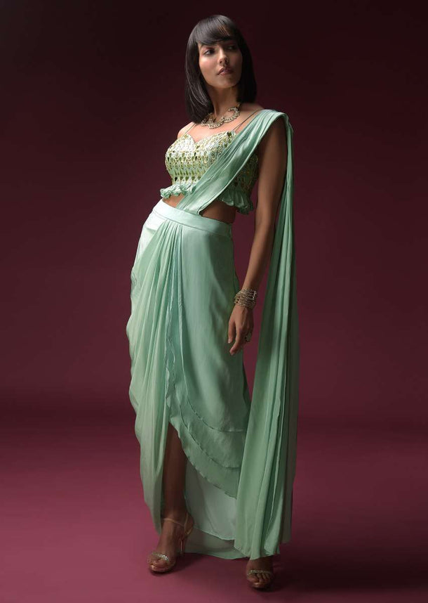 Mint Blue Dhoti Skirt With Attached Saree Drape And Ruffled Crop Top Adorned With Flower Shaped Mirror Work Online - Kalki Fashion