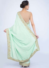 Mint green crepe silk saree with butti and border only on Kalki