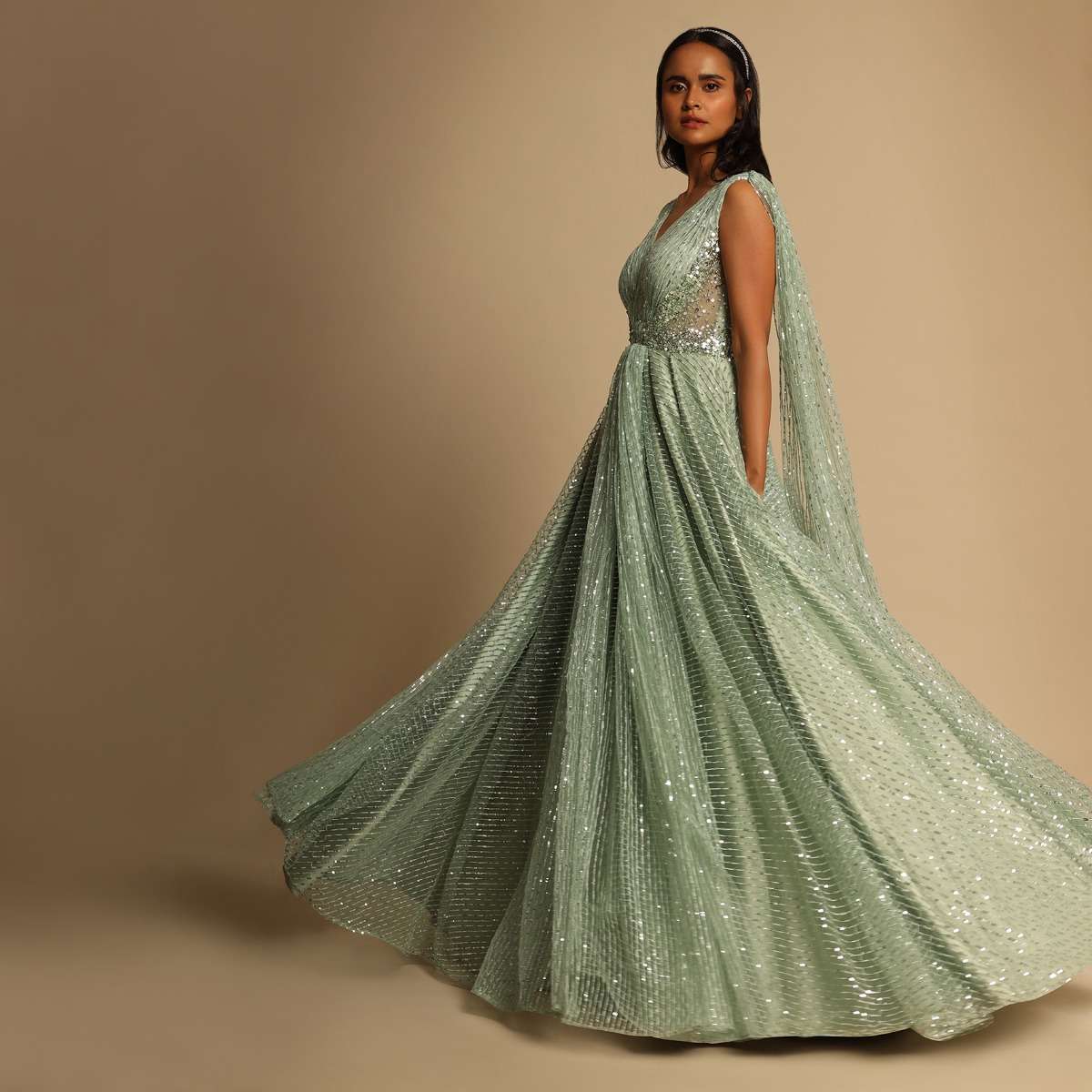 Mint Green Gown In Sequins Embellished Net With Ruching In The Front, Sheer Sides And Net Cape On Each Shoulder Online - Kalki Fashion