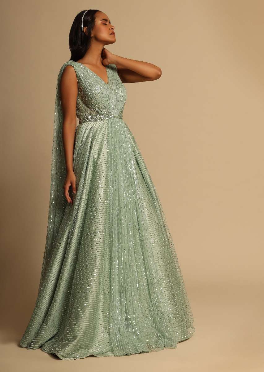 Mint Green Gown In Sequins Embellished Net With Ruching In The Front, Sheer Sides And Net Cape On Each Shoulder Online - Kalki Fashion