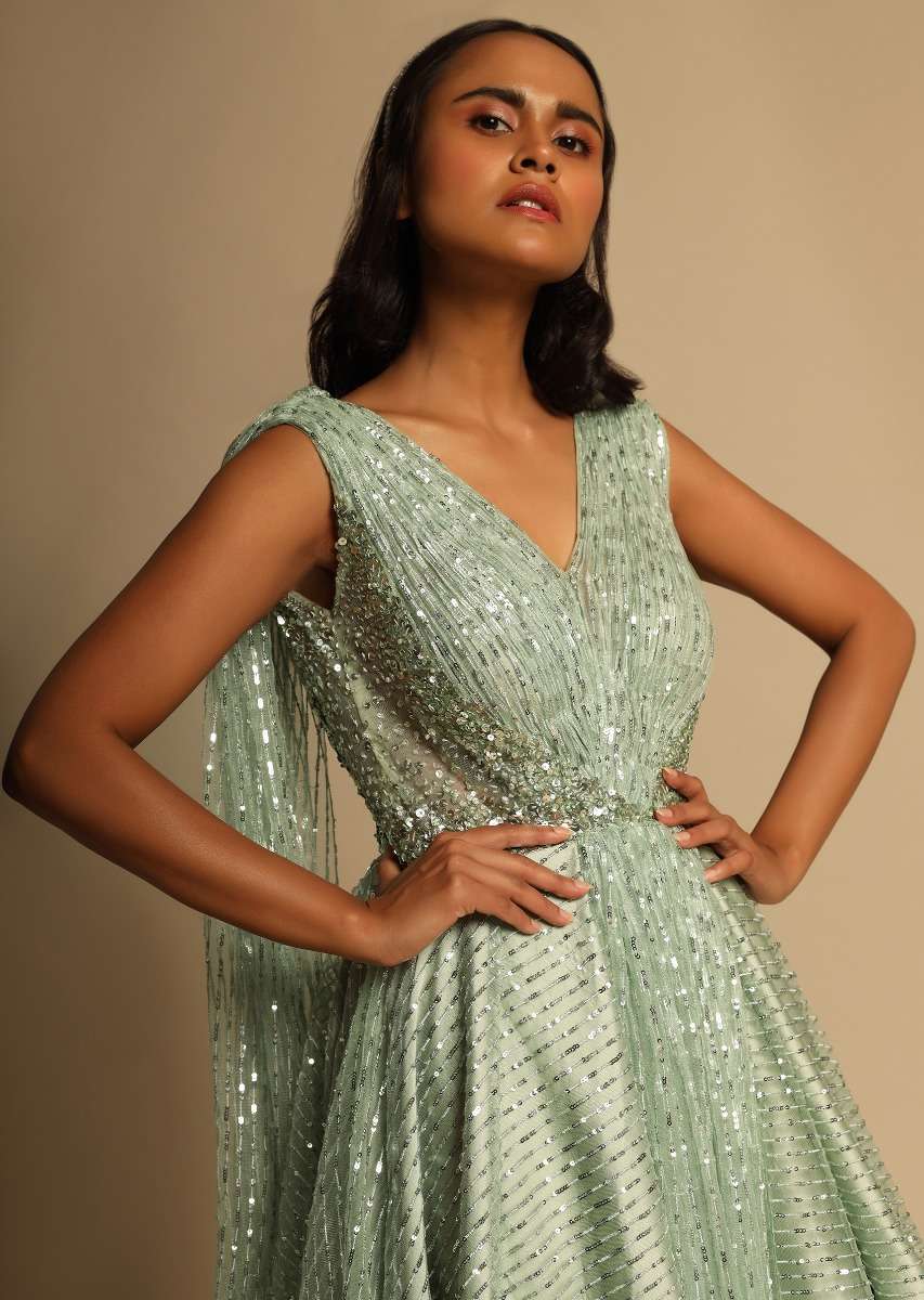 Mint Green Gown In Sequins Embellished Net With Ruching In The Front, Sheer Sides And Net Cape On Each Shoulder Online - Kalki Fashion