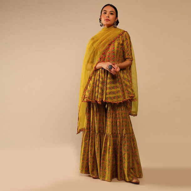 Mustard Sharara Suit In Cotton Blend With Peplum Kurti Adorned In Floral Print And Thread Embroidery