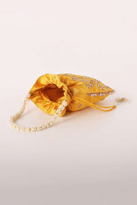 Mustard Yellow Potli In Satin With Hand Embroidery Detailing Using Zardosi Work In Floral Design All Over