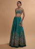 Ocean Green Lehenga Choli In Raw Silk With Resham Embroidered Spring Blooms And Scallop Hem