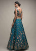 Ocean Green Lehenga Choli In Raw Silk With Colorful Resham Embroidered Spring Blossoms