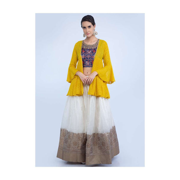 Off white floral brocade lehenga with navy blue batik printed crop top and yellow georgette jacket only on Kalki