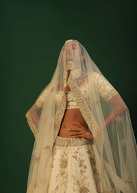 Off White Lehenga Choli In Raw Silk With Golden Cut Dana And Sequins Embroidered Floral Kalis And Geometric Border