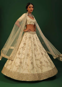 Off White Lehenga Choli In Raw Silk With Golden Cut Dana And Sequins Embroidered Floral Kalis And Geometric Border