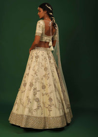 Off White Lehenga Choli In Raw Silk With Golden Cut Dana And Sequins Embroidered Floral Kalis And Geometric Border