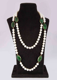 Off white long pearl necklace enhanced with emerald green semi precious stone only on Kalki